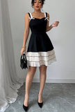 FJØRNA summer party dress, black and white mini dress with a chic, stylish look perfect for festive occasions.