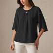 Black FJØRNA women's summer pleated blouse, casual top with a relaxed fit and stylish design, perfect for warm weather wear.