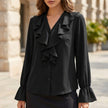 Black women's summer blouse by FJØRNA featuring a V-neck, long sleeves, and ruffle details.