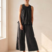 Black FJØRNA women's two-piece co-ord set with ruffle high neck top and matching pants, stylish and elegant for casual or dressy wear.
