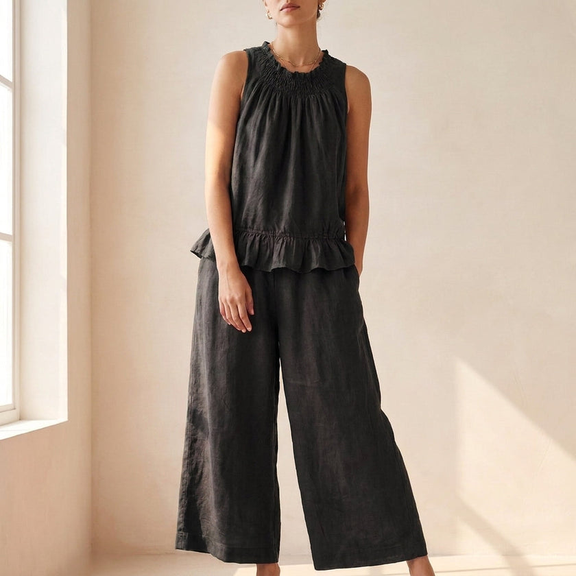 Black FJØRNA women's two-piece co-ord set with ruffle high neck top and matching pants, stylish and elegant for casual or dressy wear.