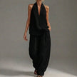 Black FJØRNA two-piece halter V-neck suit with wide-leg trousers, stylish and lightweight for casual or semi-formal wear.