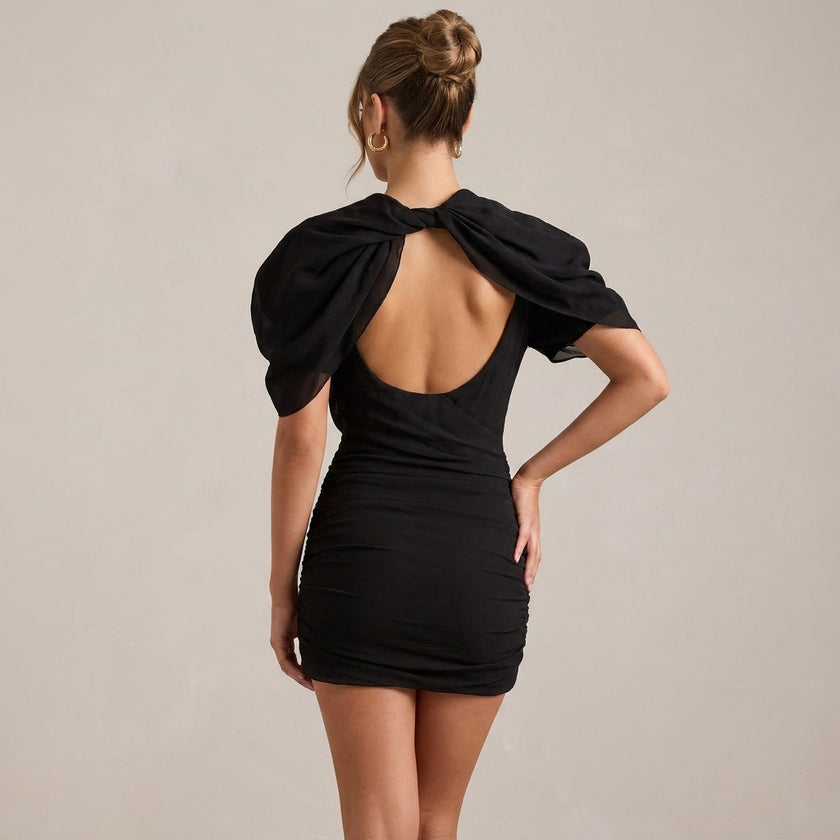 Black puff sleeve bodycon mini dress with high neck by FJØRNA, shown from the back with a fitted silhouette and stylish design.