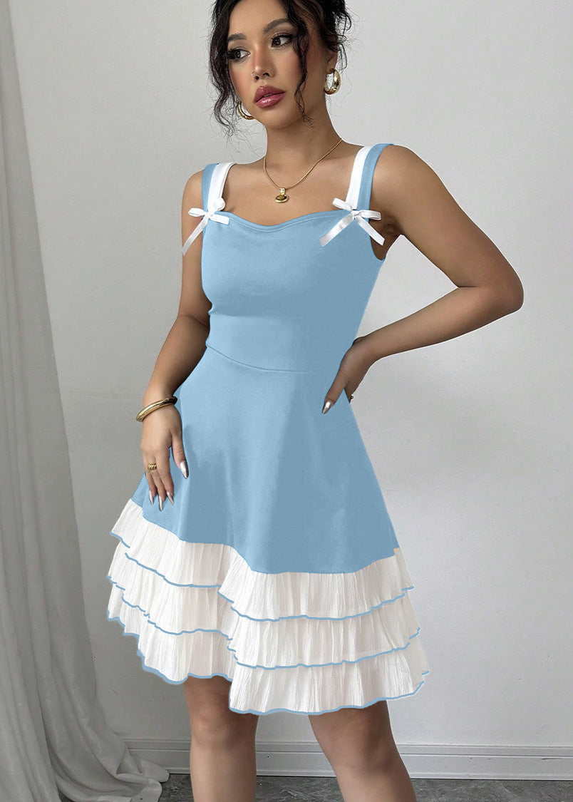 FJØRNA summer party dress featuring blue color, bow detail, and ruffle accents, front view of a stylish mini dress.