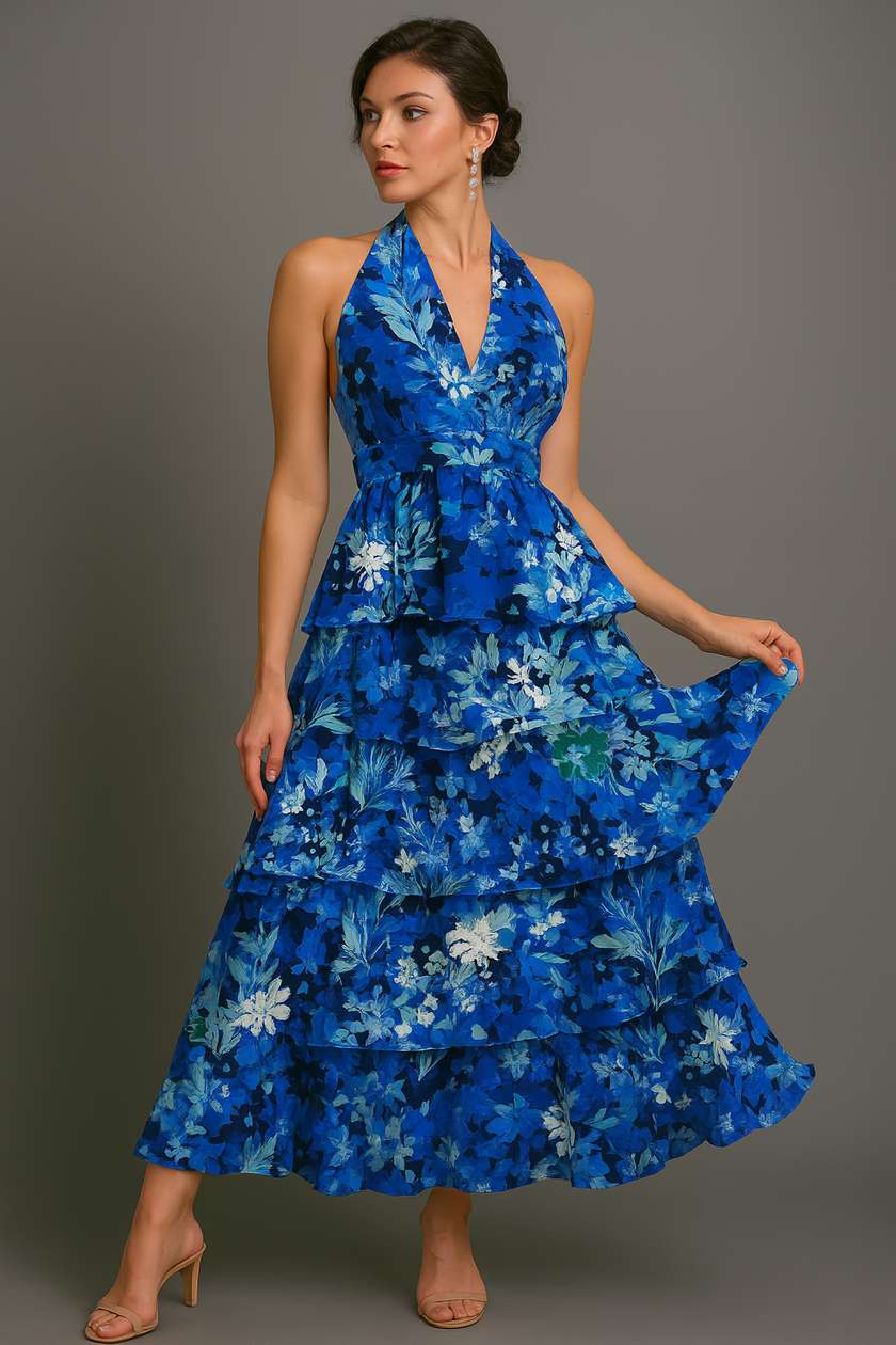 Blue FJØRNA halter floral tiered ruffle maxi dress with waist detail, featuring a vibrant floral print and flowing silhouette.