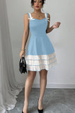 FJØRNA summer party dress, blue mini dress with bow and pleated details, perfect for festive occasions and warm weather.