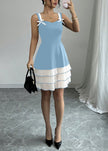 Blue FJØRNA summer party dress with ruffles, mini length, perfect for warm-weather celebrations and festive occasions.