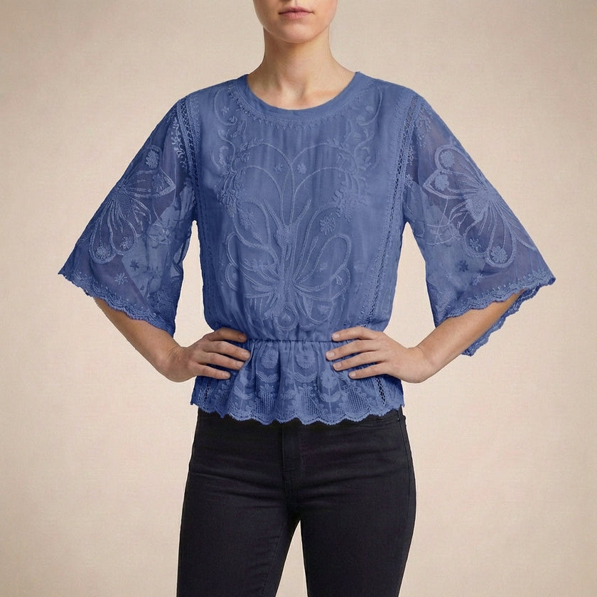 Blue floral lace summer blouse for women by FJØRNA, featuring lightweight fabric and feminine lace details.