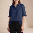 Blue denim summer blouse for women with ruffle details, casual style by FJØRNA, perfect for warm-weather casual outfits.
