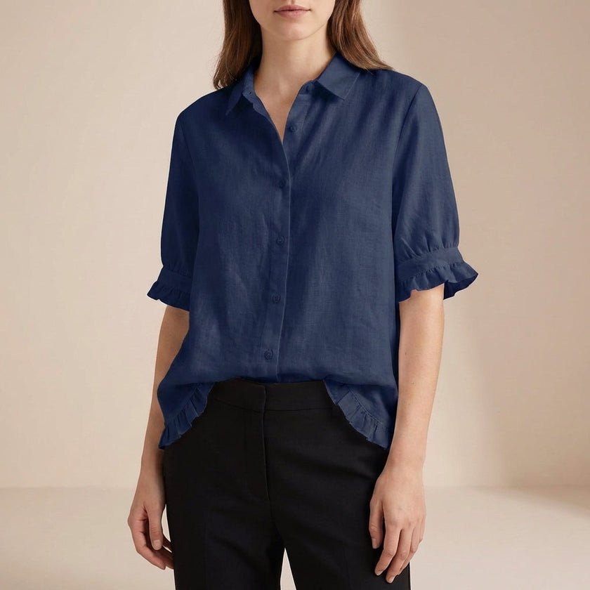 Blue denim summer blouse for women with ruffle details, casual style by FJØRNA, perfect for warm-weather casual outfits.