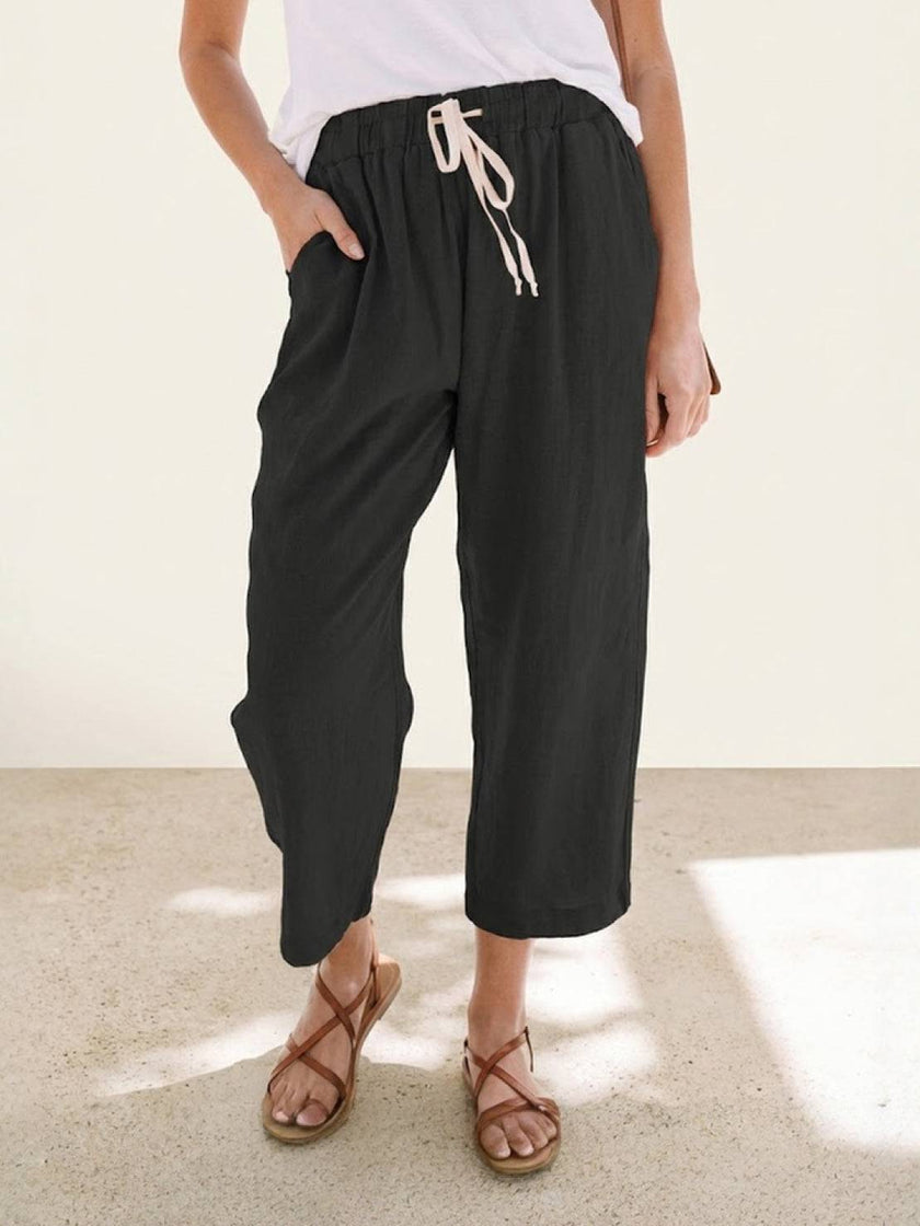 FJØRNA linen summer trousers for women with straight leg fit, drawstring waist, and breathable, relaxed style.