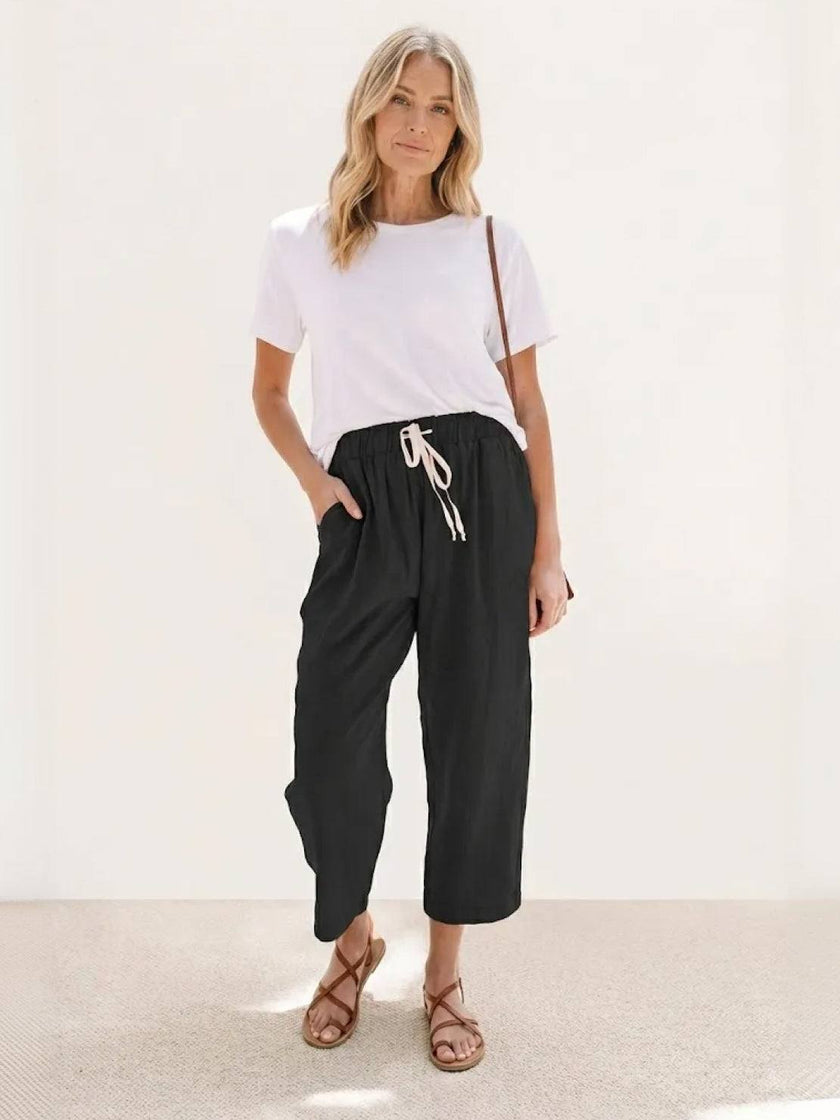 FJØRNA linen summer trousers for women with straight leg fit, drawstring waist, breathable and relaxed for warm weather wear.