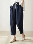 FJØRNA linen summer women's trousers with straight-leg fit and drawstring waist, breathable and relaxed for warm weather.