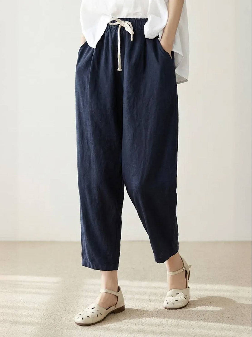 FJØRNA linen summer women's trousers with straight-leg fit and drawstring waist, breathable and relaxed for warm weather.