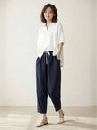 FJØRNA linen summer trousers for women with straight leg cut, drawstring waist, breathable and relaxed fit, suitable for warm weather.