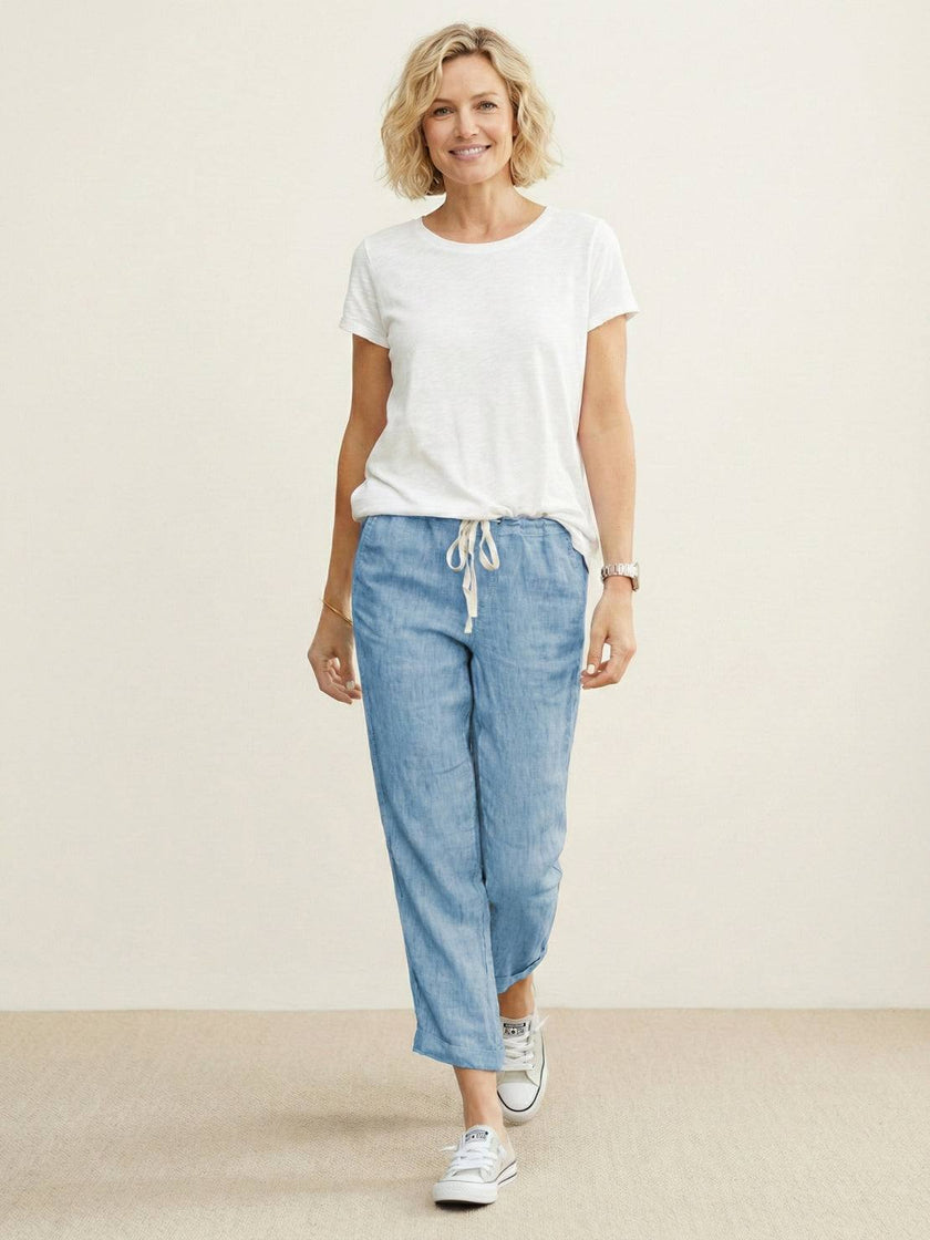 FJØRNA linen summer trousers for women with a breezy, relaxed fit, straight leg design, and drawstring waist for breathable comfort.