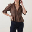 FJØRNA women's brown summer blouse with V-neck, puff sleeves, and lace detailing, stylish and lightweight for warm weather.