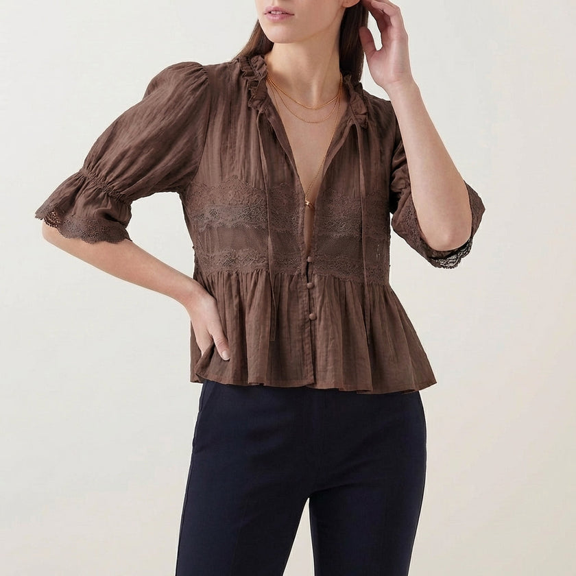 FJØRNA women's brown summer blouse with V-neck, puff sleeves, and lace detailing, stylish and lightweight for warm weather.