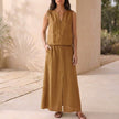 FJØRNA women's two-piece co-ord set in brown with V-neck top and matching pants, featuring side pockets and a stylish, elegant design.