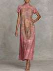 FJØRNA loose white maxi dress with short sleeves, contrast color flower print, mock neck, and flowing design.