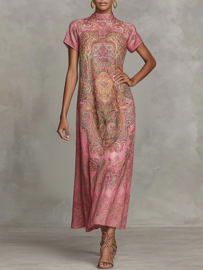 FJØRNA loose white maxi dress with short sleeves, contrast color flower print, mock neck, and flowing design.