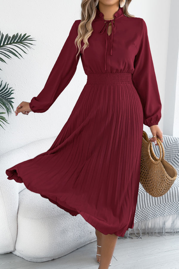 FJØRNA solid color long-sleeved fitted waist pleated midi dress with elegant design, showcasing its sleek silhouette and pleated skirt.