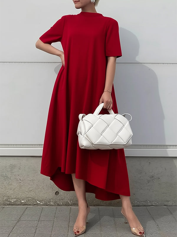 FJØRNA high-low white maxi dress with short sleeves, solid color, flowing fabric, and elegant silhouette.