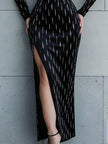 FJØRNA square-neck embellished long-sleeve maxi dress with high slit, elegant design, and intricate details in a flowing silhouette.