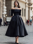 Elegant off-shoulder satin midi dress by FJØRNA featuring a flowing silhouette and stylish design for formal occasions.