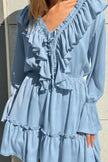 FJØRNA solid color V-neck ruffled ruched long-sleeve vacation mini dress, casual wedding dress style, shown on a model.
