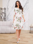 Elegant white gas dress by FJØRNA featuring flowing fabric and a sophisticated silhouette, perfect for formal occasions.