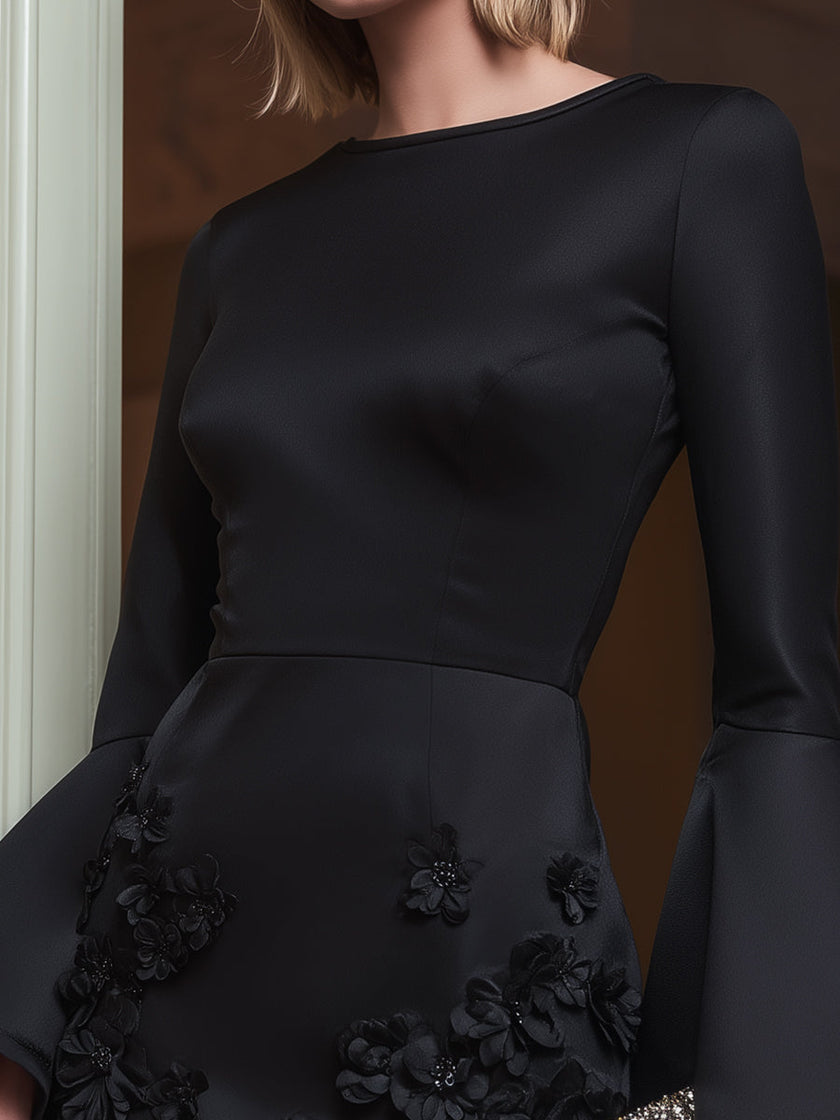 Black bell-sleeve floral appliqué mini dress by FJØRNA featuring a stylish floral pattern and bell sleeves.