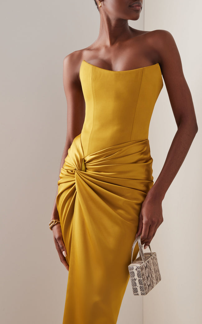 FJØRNA draped strapless satin maxi dress, elegant formal gown with flowing fabric and fitted bodice, suitable for special occasions.