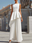 White FJØRNA maxi dress featuring sculpted asymmetric peplum and pleated design, elegant and flowing for women.