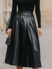 FJØRNA black turtleneck and leather pleated skirt set, stylish women's dress, featuring a sleek black turtleneck and leather skirt.