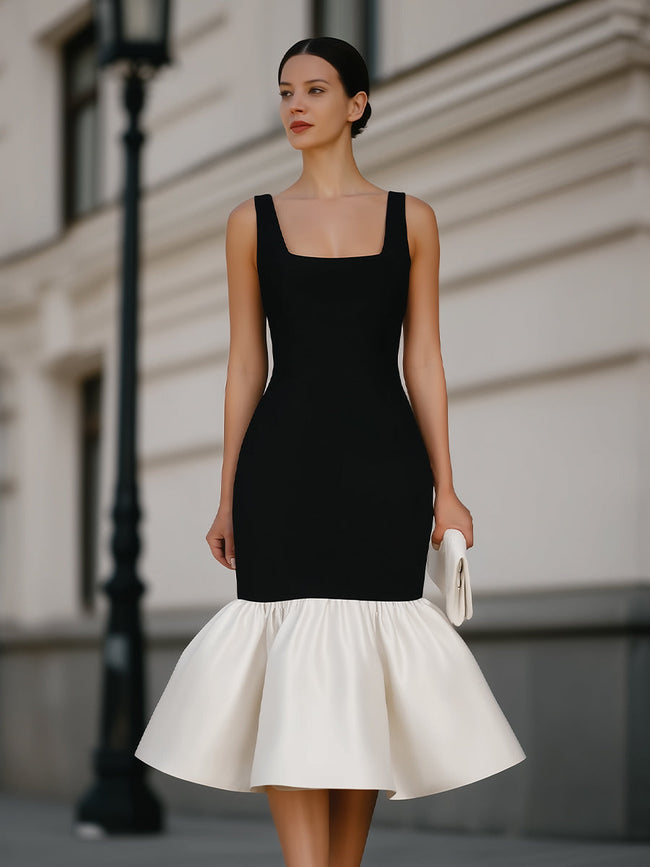 FJØRNA square neck sleeveless ruffle hem midi dress displayed on a hanger, showcasing its elegant design and flowing fabric.