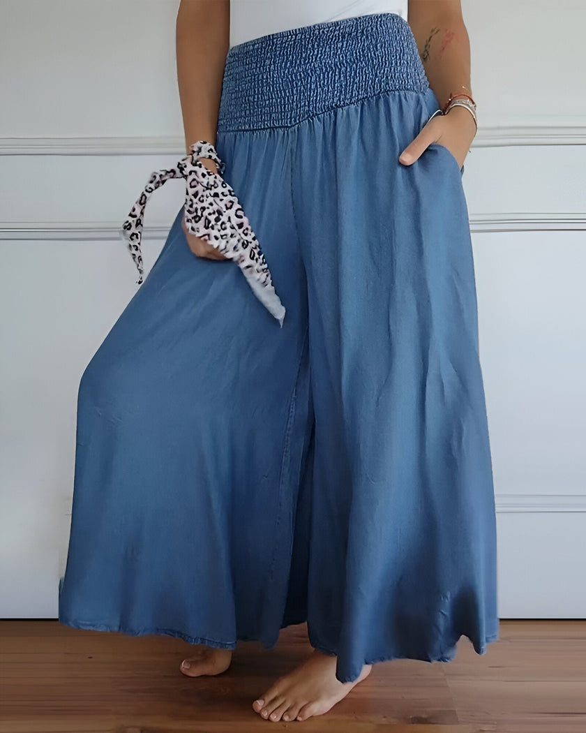 FJØRNA lightweight summer women's trousers with relaxed fit, elastic waist, and breathable fabric, shown in a natural relaxed pose.