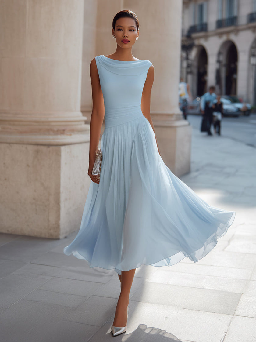 FJØRNA draped neck sleeveless pleated midi dress displayed on a model, showcasing elegant fabric and stylish design.