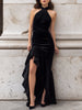 FJØRNA black velvet halter evening gown with knotted front, high slit, and flowing maxi dress design, suitable for formal occasions.