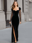 Black velvet sweetheart gown with sheer sleeves by FJØRNA, featuring a flowing black maxi dress design.