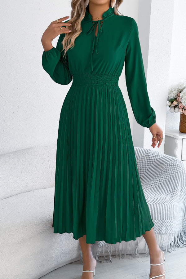 FJØRNA solid color long-sleeved fitted waist pleated midi dress displayed on a hanger, showcasing its elegant design and fabric details.