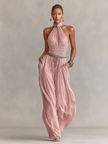FJØRNA blush pleated jumpsuit for women featuring halter neck, ruched waist, and wide-leg pants, stylish and elegant.