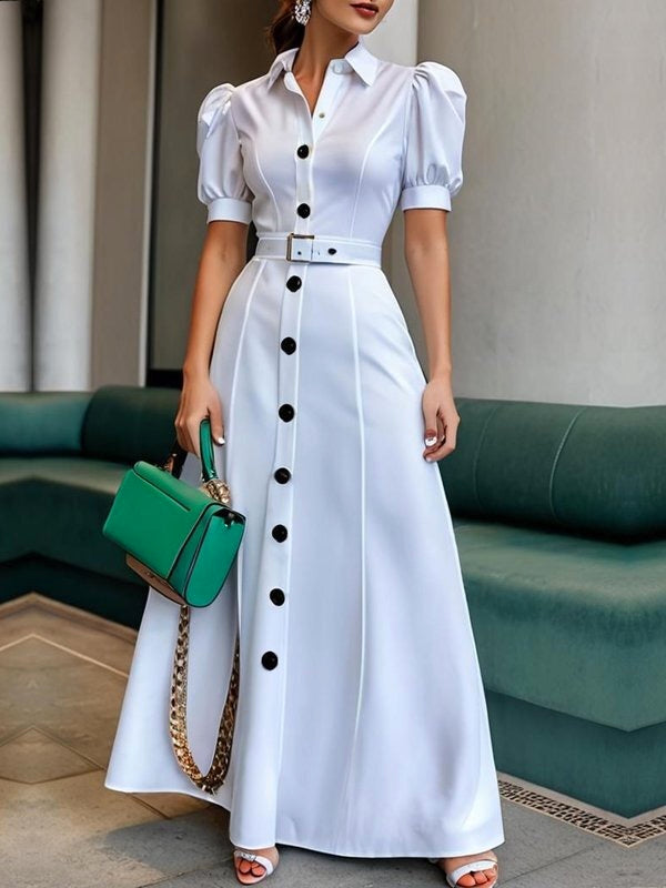 White FJØRNA maxi dress with puff short sleeves, belted waist, button details, and a lapel collar, perfect for elegant summer wear.