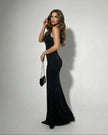 FJØRNA black satin maxi dress for women, elegant stretch gown with a flowing silhouette and glamorous design.