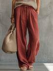 Brick red cotton linen wide-leg trousers for women by FJØRNA, shown with a relaxed fit and natural waistline.