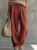 Brick red cotton linen wide-leg trousers for women by FJØRNA, shown with a relaxed fit and natural waistline.