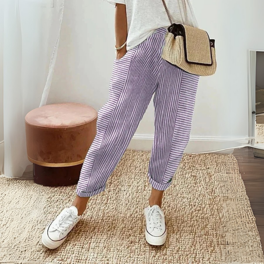 FJØRNA women's lightweight summer trousers with wide legs, striped design, breathable fabric, and side pockets.