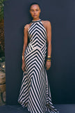 FJØRNA Mono Fluid Stripe Maxi Halter Dress displayed on a model, featuring bold horizontal stripes and a flowing maxi silhouette.