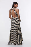 FJØRNA Mono Fluid Stripe Maxi Halter Dress featuring a flowing fabric, bold stripe pattern, and halter neckline for elegant summer wear.