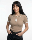 Women’s FJØRNA cotton polo top, close-up of classic collar and button placket, soft white fabric, casual and comfortable style.